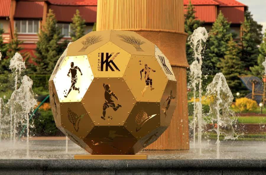 Gold geometric metal sculpture with perforated logo branding Gold geometric metal sculpture with perforated logo branding