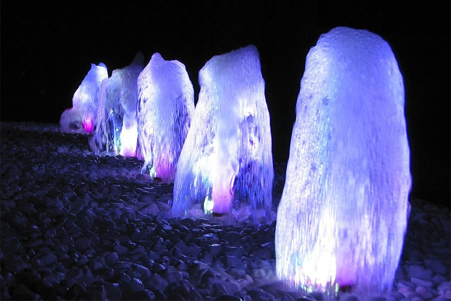 LED Foam Jet Fountain LED foam jets on white decorative stones at night