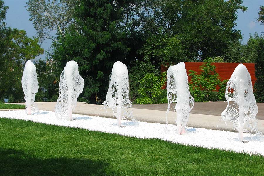Foam Jet Fountain in Modern residential Garden Soft foamy jets emerging from white stone landscaping in a modern garden