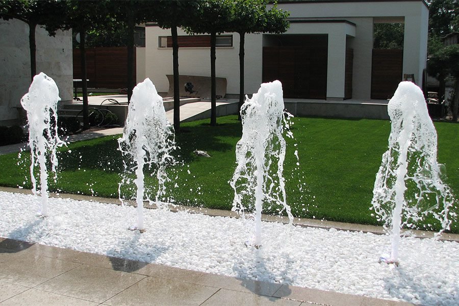Architectural Foam Jet Water Feature Architectural foam jet nozzles integrated into white stone landscaping
