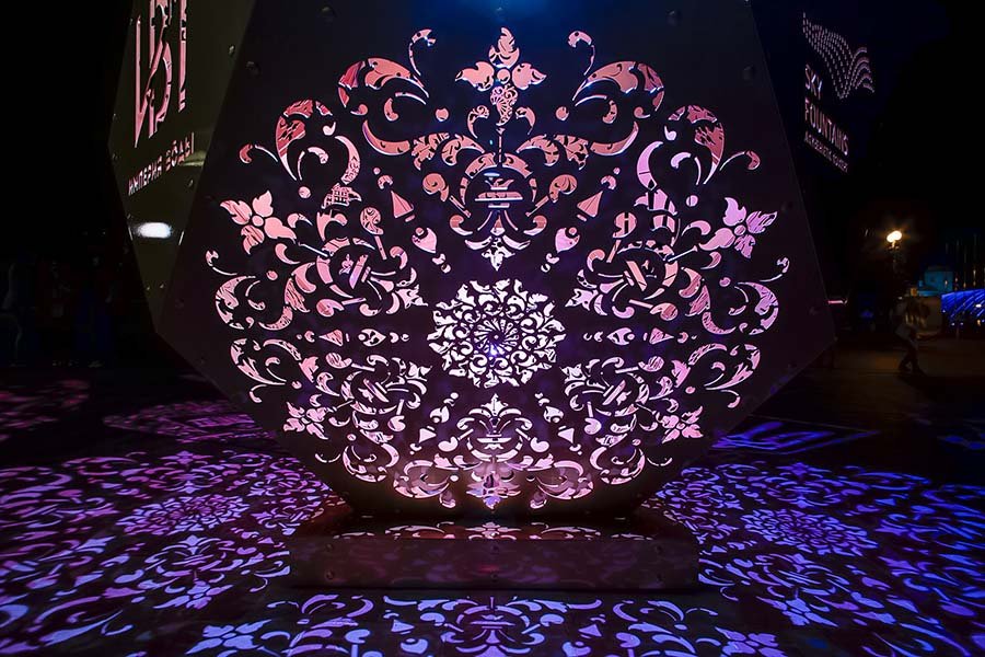 perforated metal sculptured art with light in public space perforated metal art with purple light
