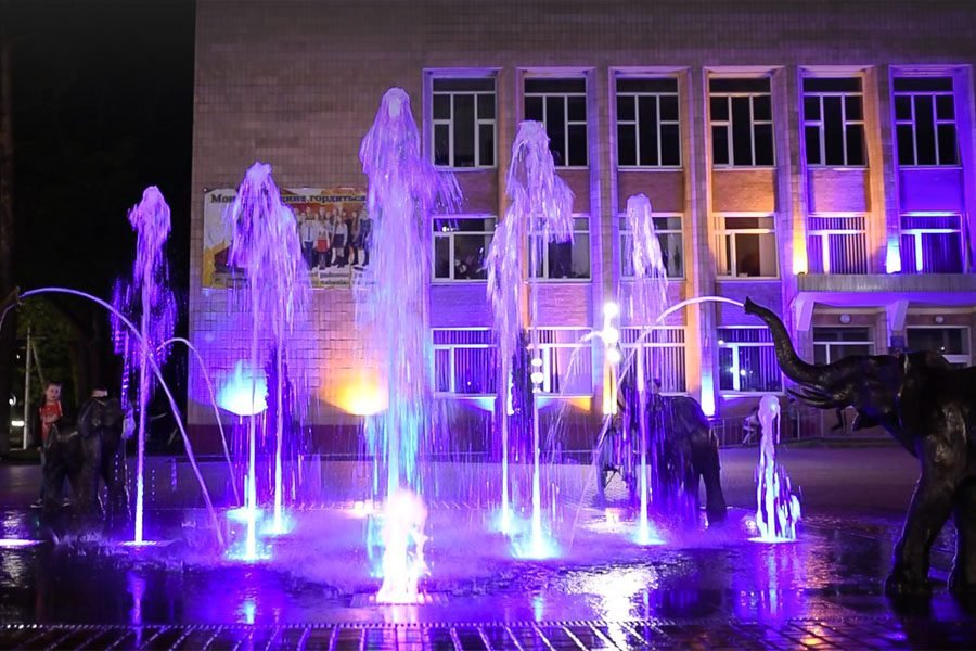 Interactive public fountain installation with dynamic LED lighting and sculptural elements for urban plazas and municipal landscape projects Interactive LED-lit public fountain with animal sculptures