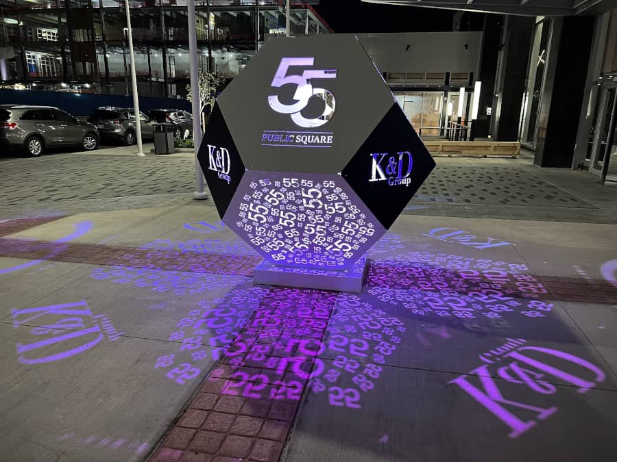 illuminated branded art feature with projected light illuminated branded art feature