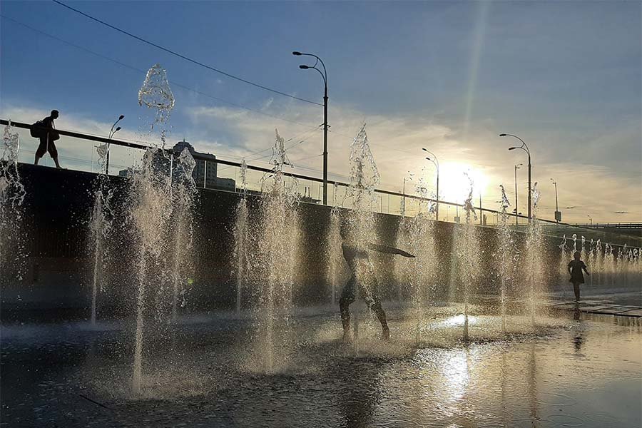 Children in a fountain Children running in a fountain at sunset