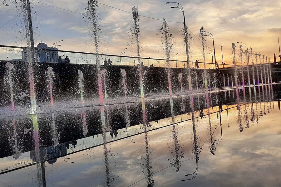 reflection of jets Fountain in the evening with reflection of sky and jets