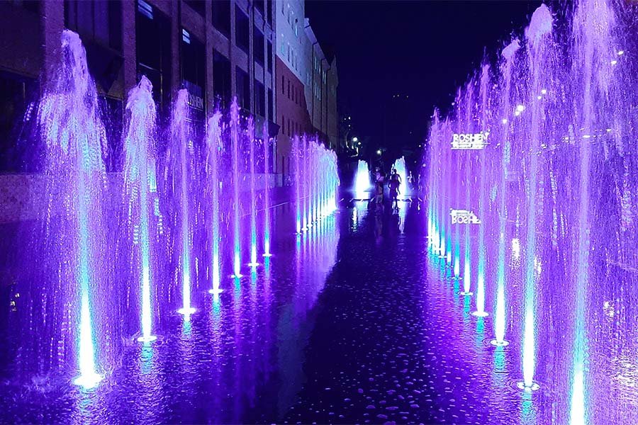 Purple illuminated fountain show in Kyiv Dry deck fountain in Kyiv in 2020 illuminated with bright purple LED jets