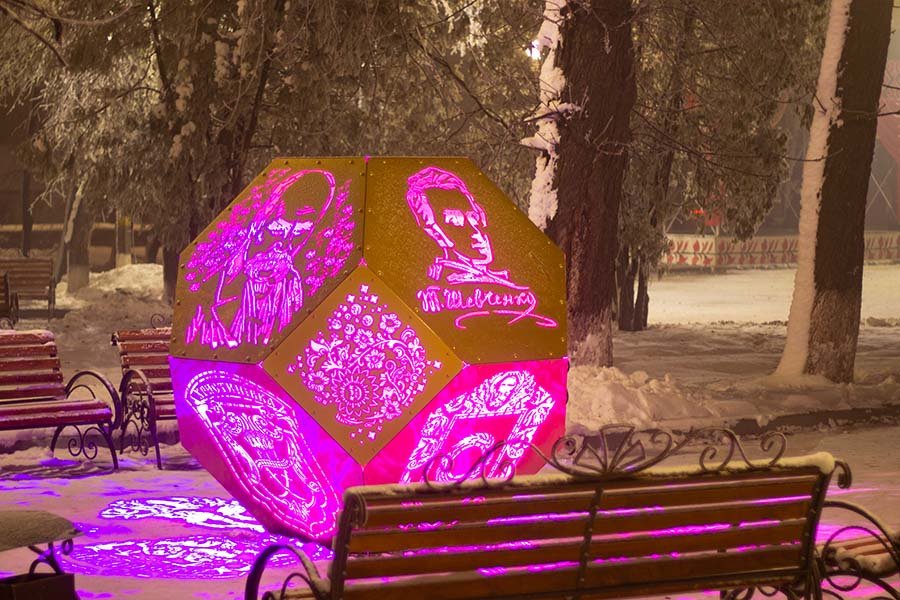 LED-illuminated metal sculpture with portrait and cultural ornamental patterns Metal cultural sculpture with portrait and ornamental patterns highlighted with LED