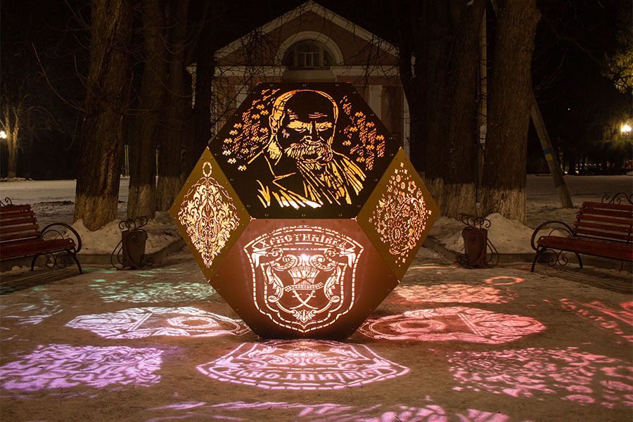 Perforated metal art installation with LED illumination and ornamental design Laser-cut metal sculpture with portrait and LED accent lighting