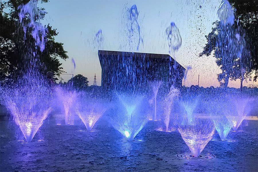 Interactive LED musical fountain with dynamic water show Interactive LED fountain with blue water effects during music show
