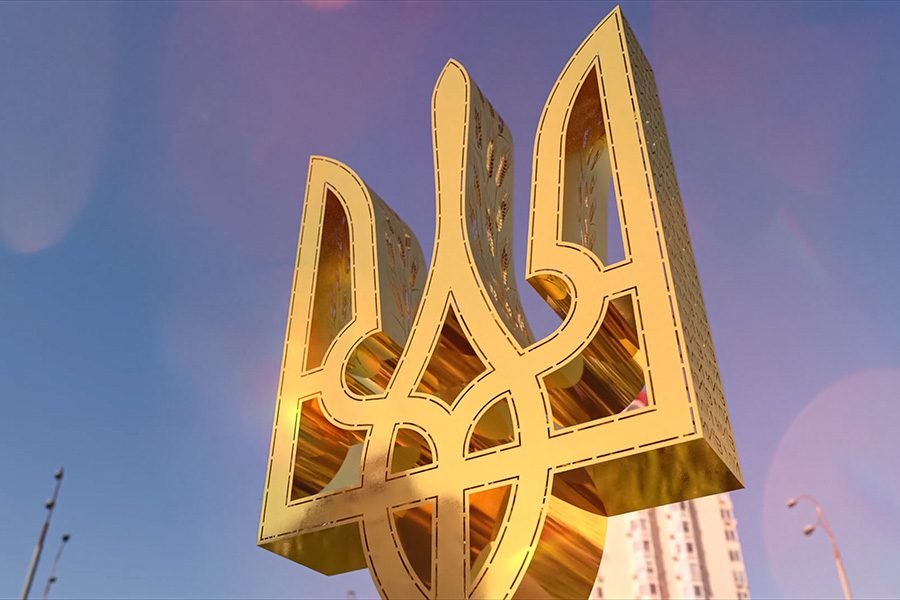large golden metal Tryzub sculpture with polished reflective finish installed outdoors as a modern Ukrainian public art landmark golden metal Tryzub Art sculpture outdoors