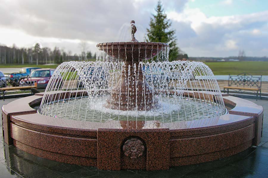 Elegant Granite Fountain for Luxury Estate Elegant tiered granite fountain with arched water jets placed in luxury estate