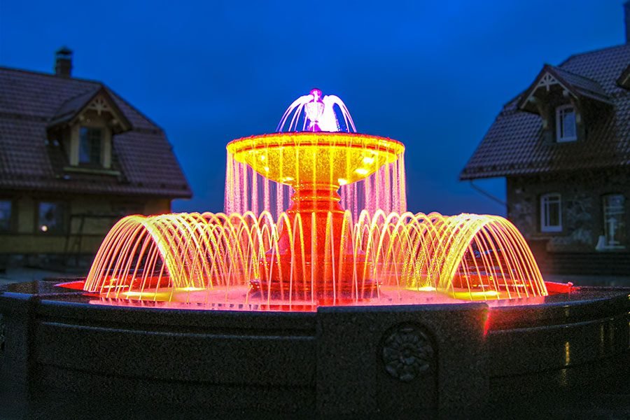 RGB Illuminated Tiered Fountain RGB-illuminated tiered fountain with arched water jets at night