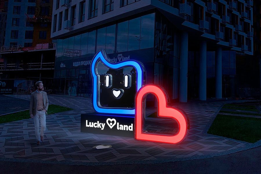 Illuminated custom branded logo sculpture with LED lighting installed in a modern urban square metal and glass LED branded logo sculpture in urban square