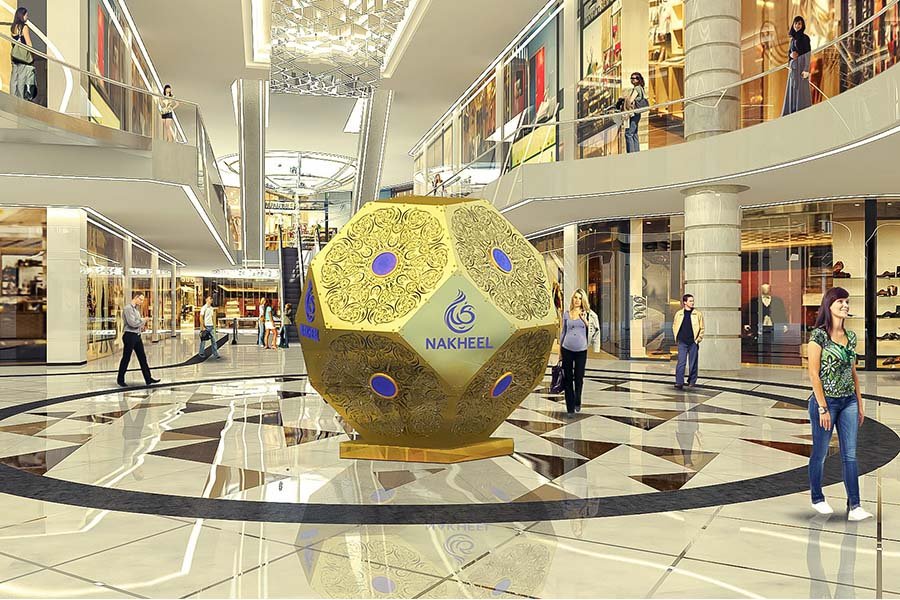 Large Gold Geometric Art Installation – custom branded metal sculpture with intricate perforated patterns displayed in mall atrium large gold geometric art installation with Nakheel logo in shopping mall atrium