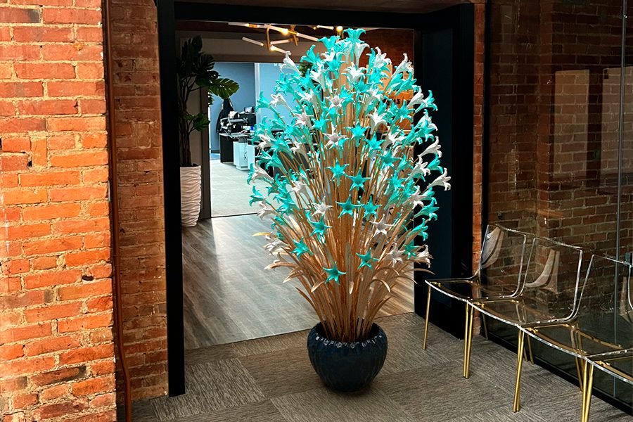 Blue Blossom Tree – art installation made from metal and glass with vibrant blue flowers, designed as an interior centerpiece metal tree art installation with blue glass flowers in modern interior