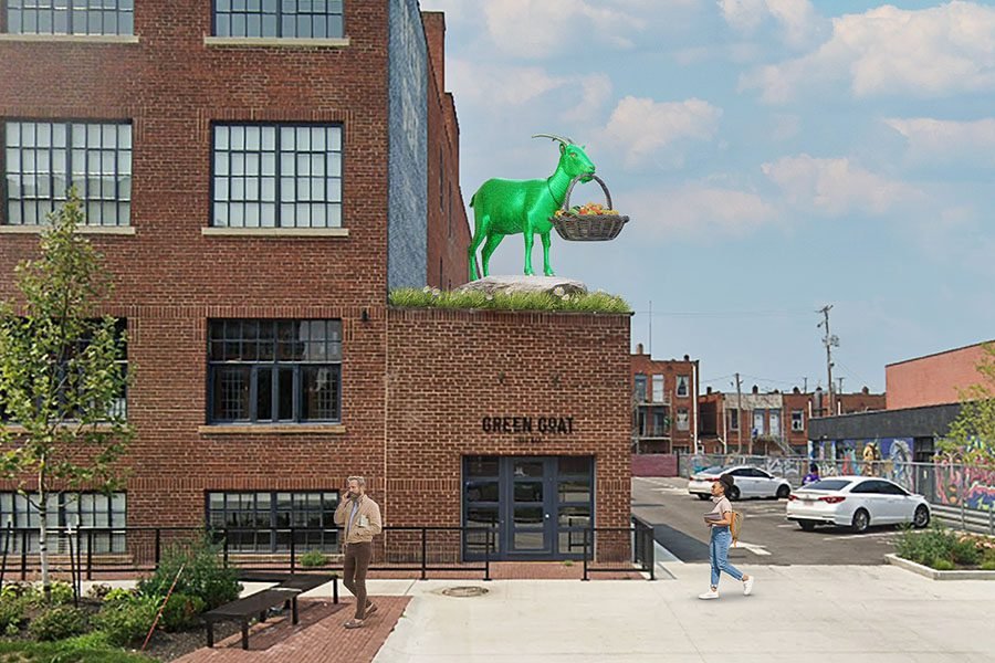 Whimsical green goat rooftop sculpture with a basket installation on the facade of a brick urban building Green goat rooftop sculpture on urban building
