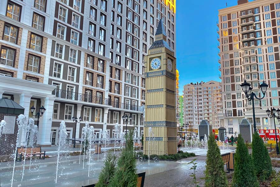decorative clock tower fountain in residential courtyard
