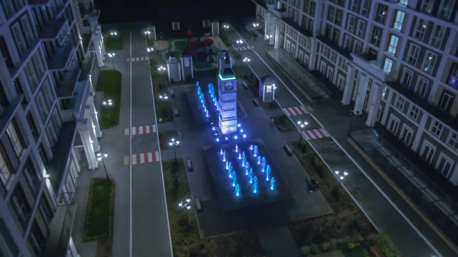 blue illuminated fountain with clock tower at night