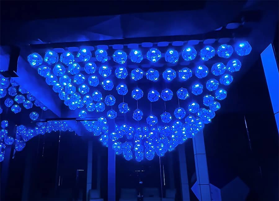 large kinetic ceiling installation with blue pendants
