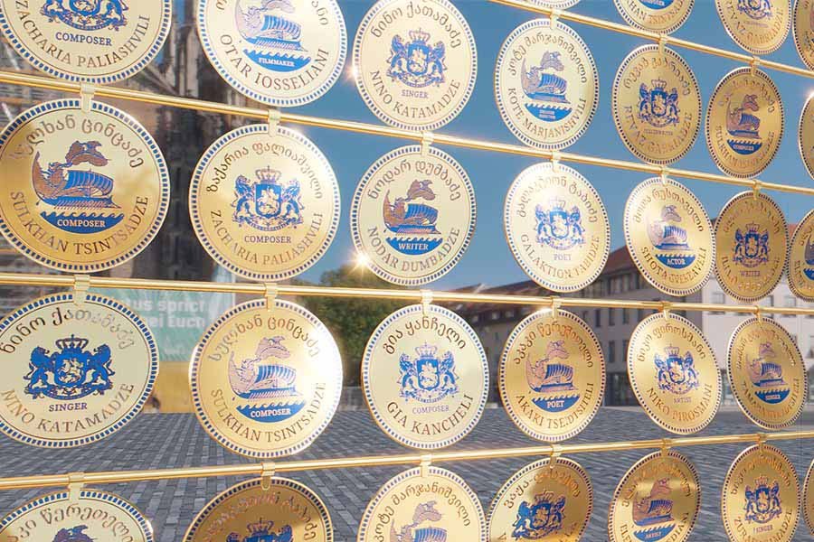 Metallic coin discs with engraved names