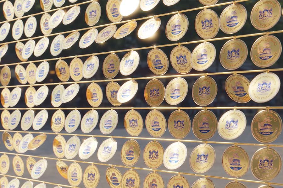 Golden circular medallions with engraved cultural symbols