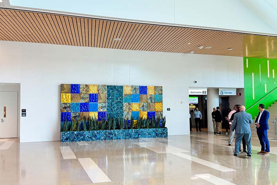 Glass and stone feature wall with live plants in a modern public interior
