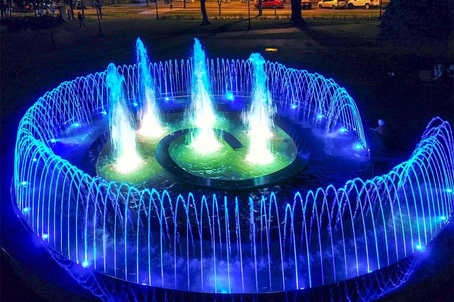 circular LED fountain with blue light arcs and center water jets