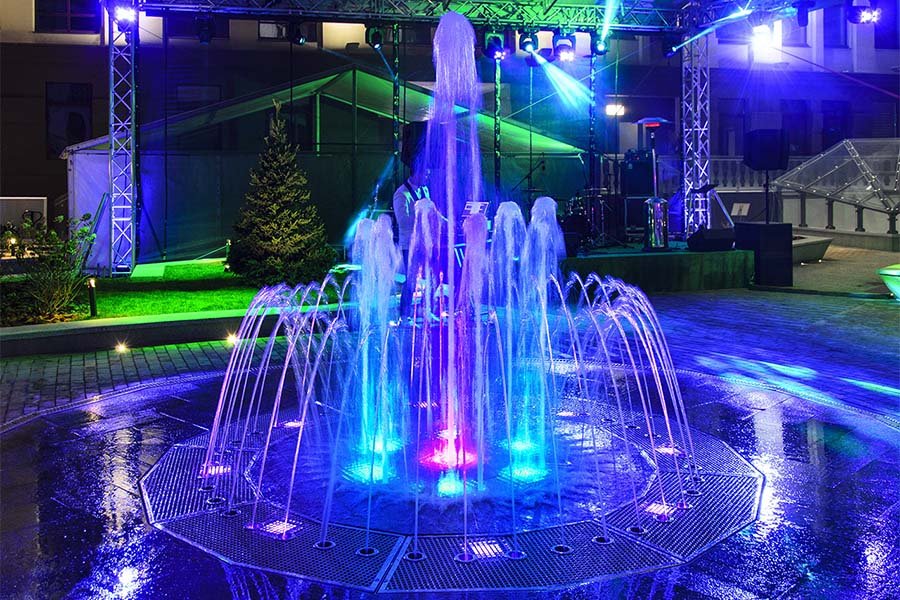Interactive dry deck fountain with colorful LED lighting