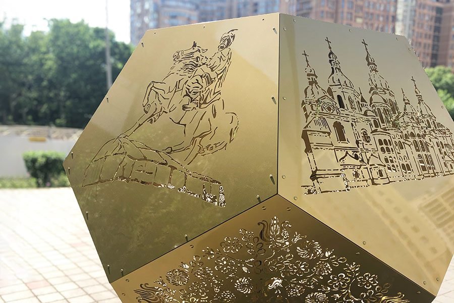 Gold metal art installation with perforated ornaments