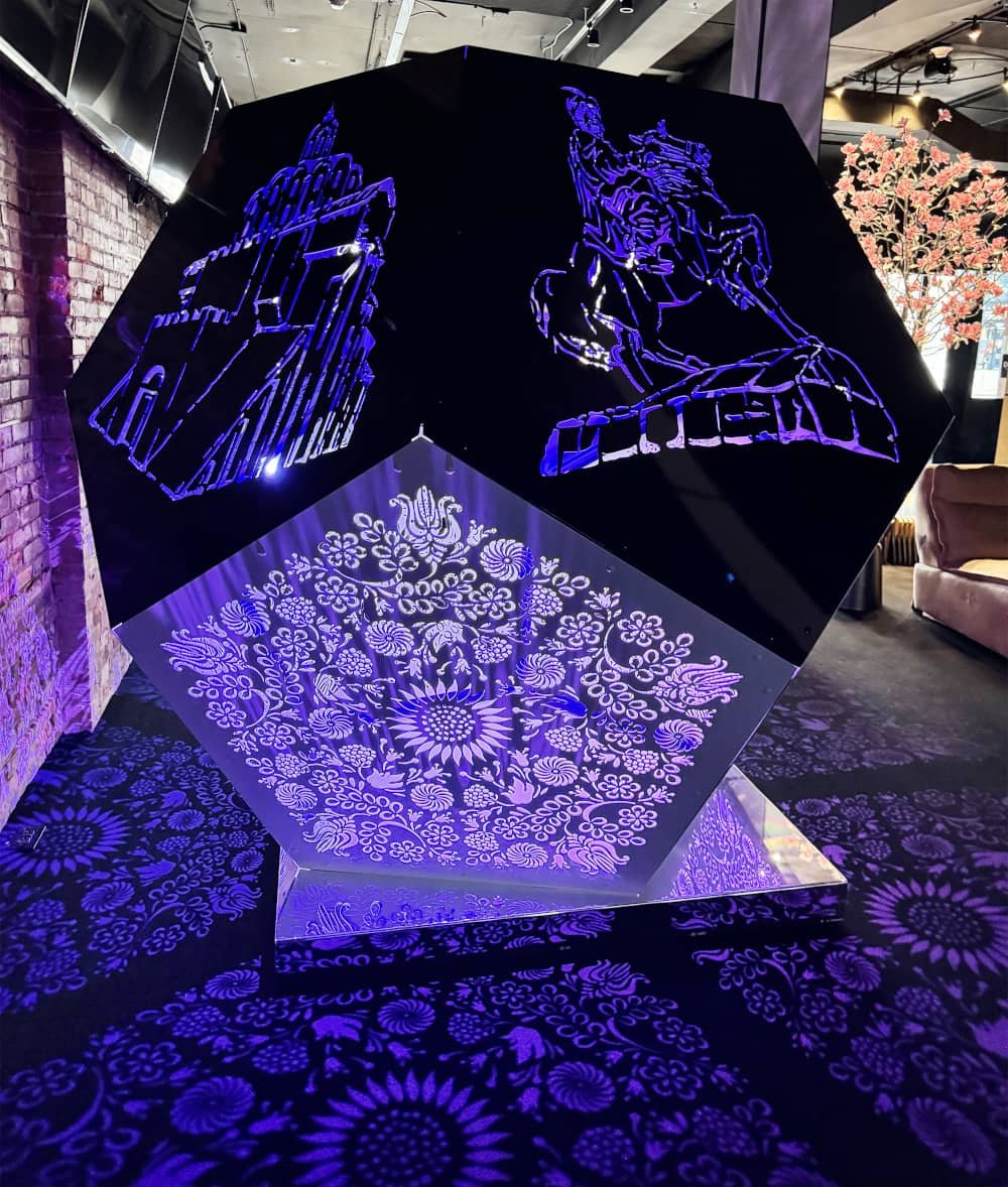 Illuminated geometric art installation with cut-out panels
