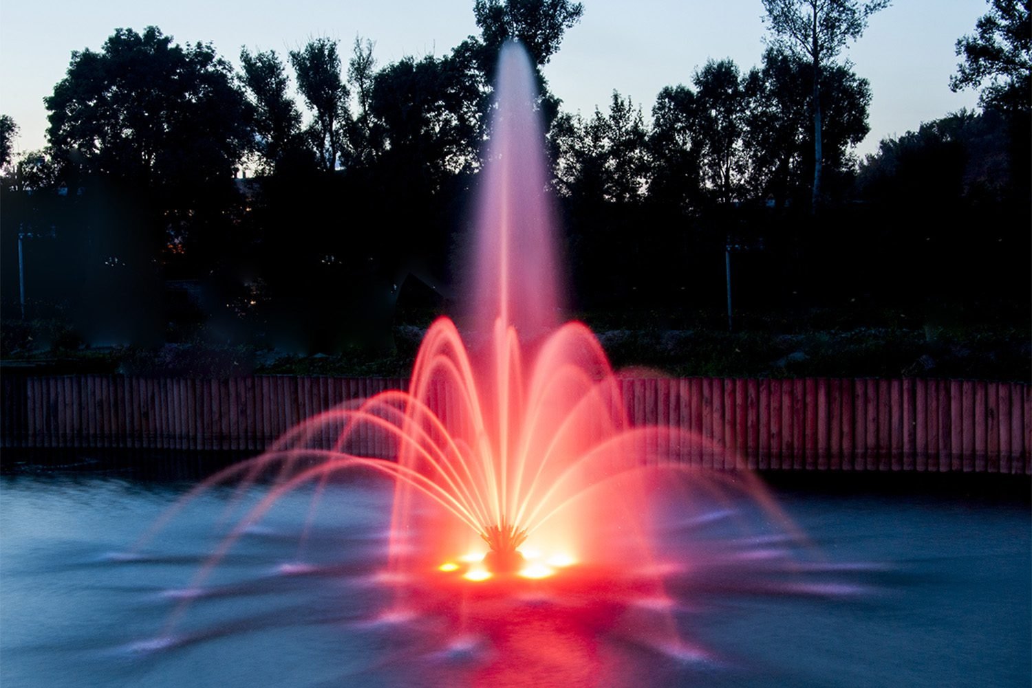 red LED pond aeration fountain at night