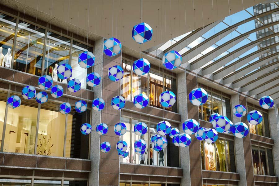 kinetic blue and white sphere installation in Miami shopping mall atrium