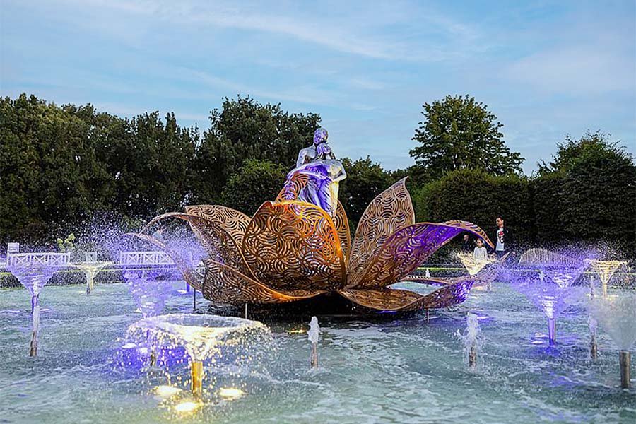 artistic fountain with culptural lotus centerpiece and light