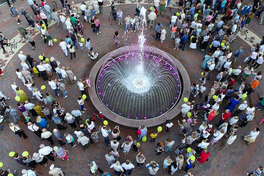 round fountain surrounded with people