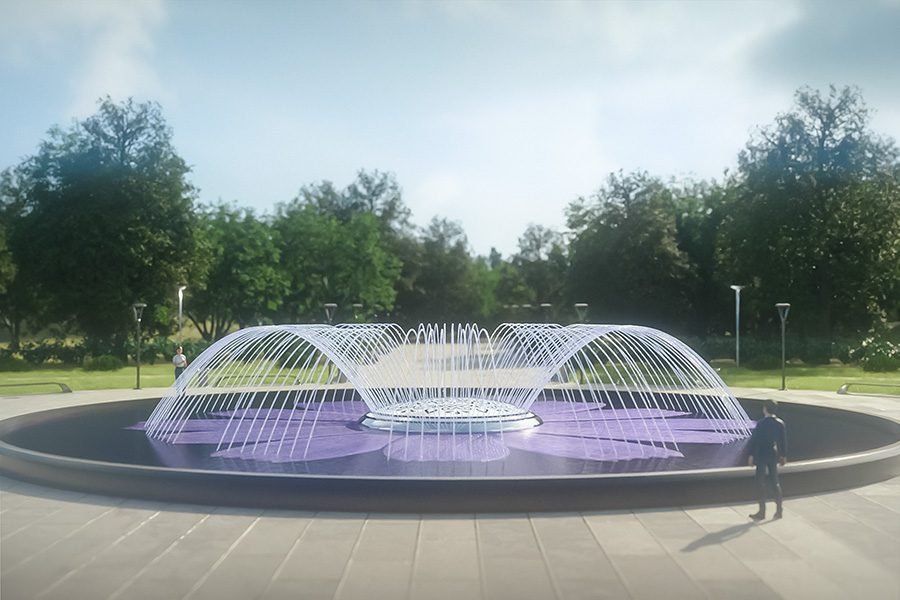 Modern circular fountain with arched water jets in a public park