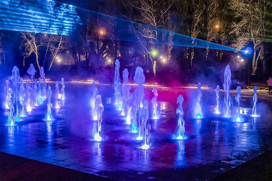 Interactive dry fountain with blue LED jets and laser lighting
