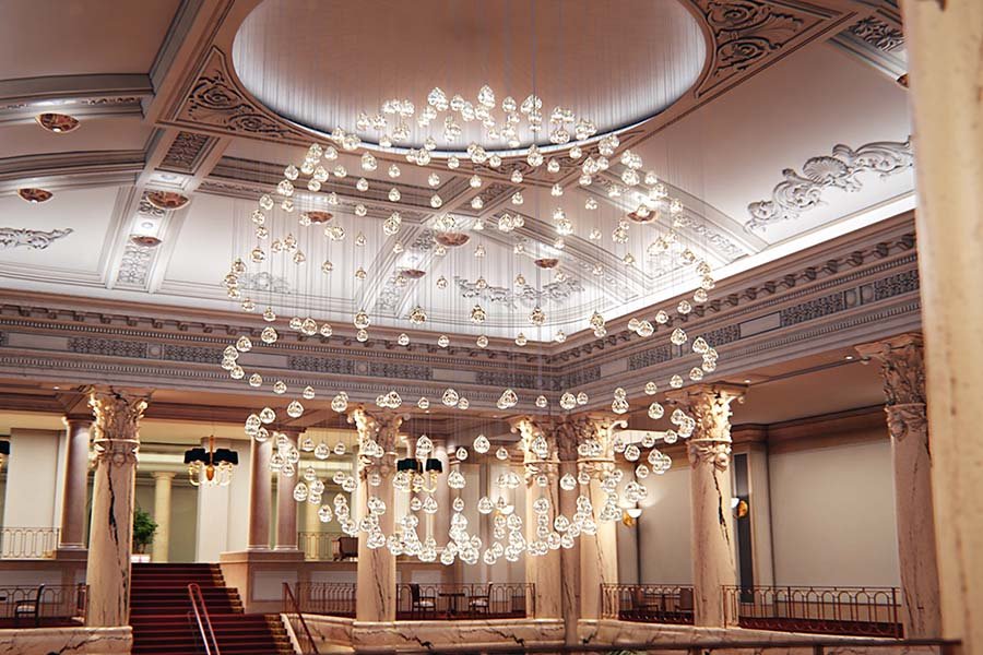 Contemporary cascading chandelier of transparent glass spheres