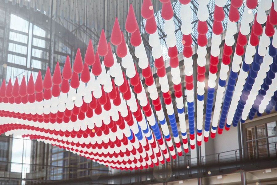 Red, white, and blue suspended droplet kinetic sculpture