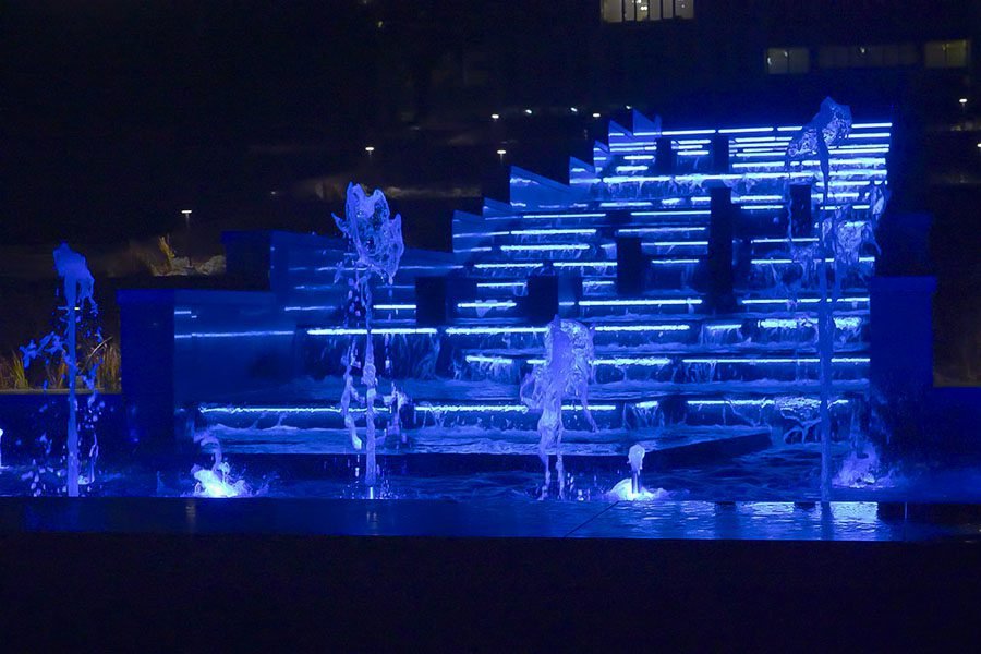 blue LED illuminated stepped cascade fountain at night