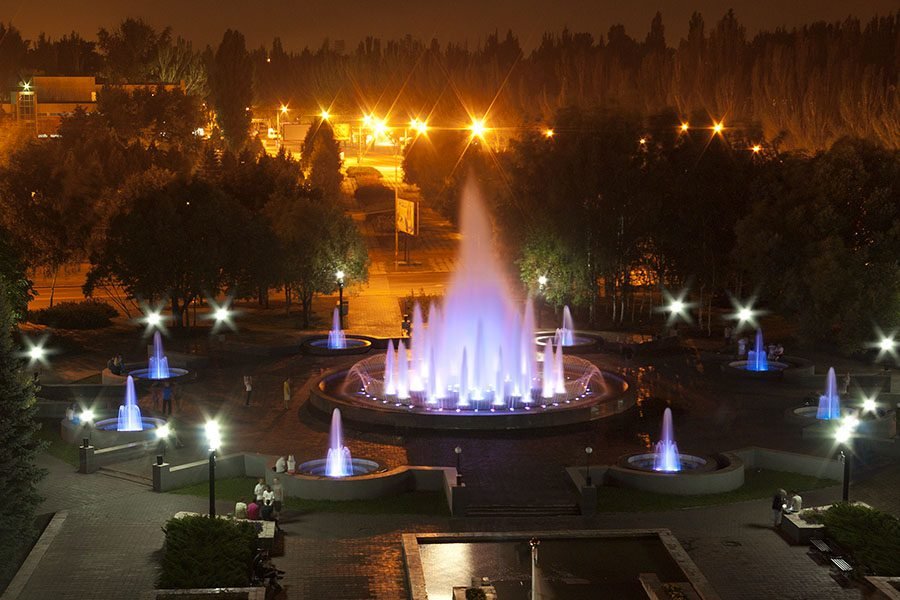 illuminated public fountain ensemble at night