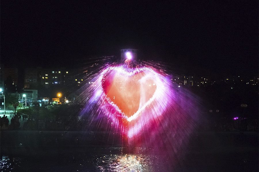 Water screen projection in heart shape at night
