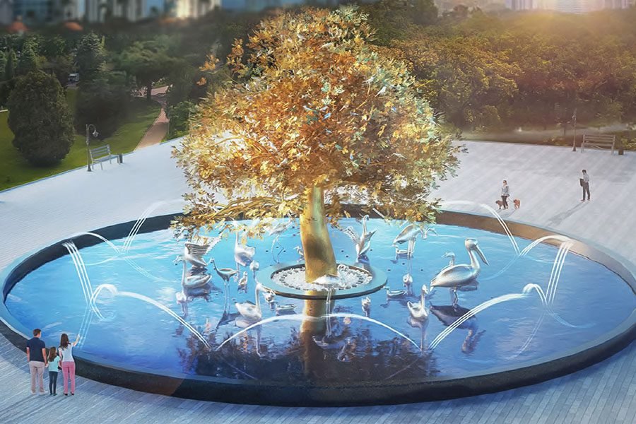 gold tree art sculpture in water pool with birds