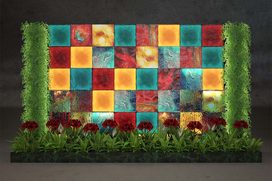 hand-blown glass wall installation with colorful panels and greenery in lobby