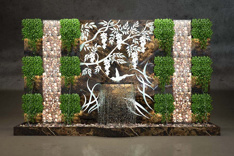 natural stone indoor waterfall wall with live plants and carved floral design