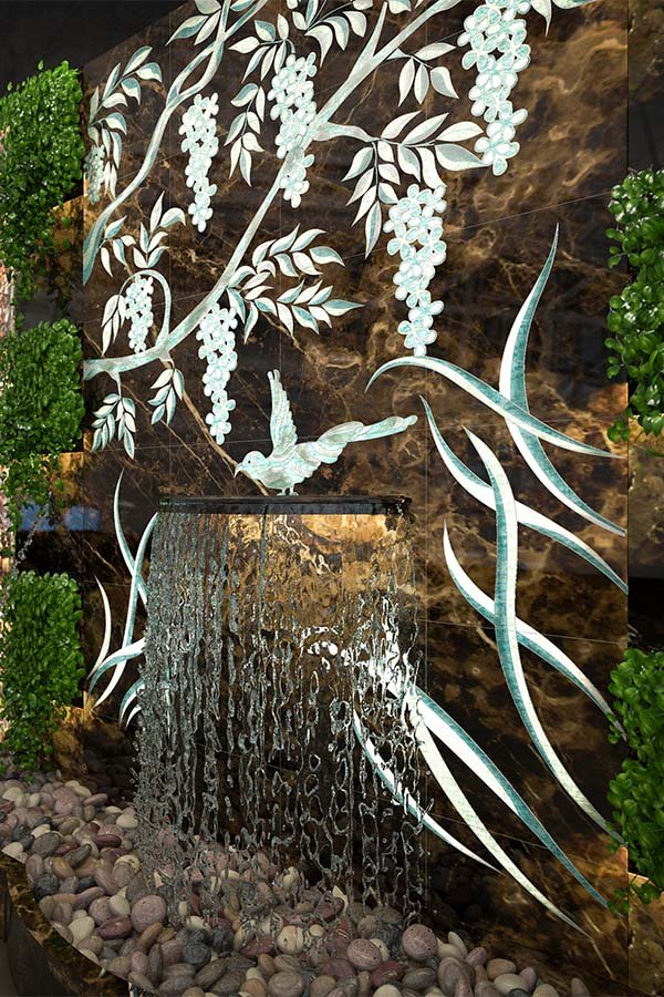 carved stone water wall with floral engraving and LED-lit water flow
