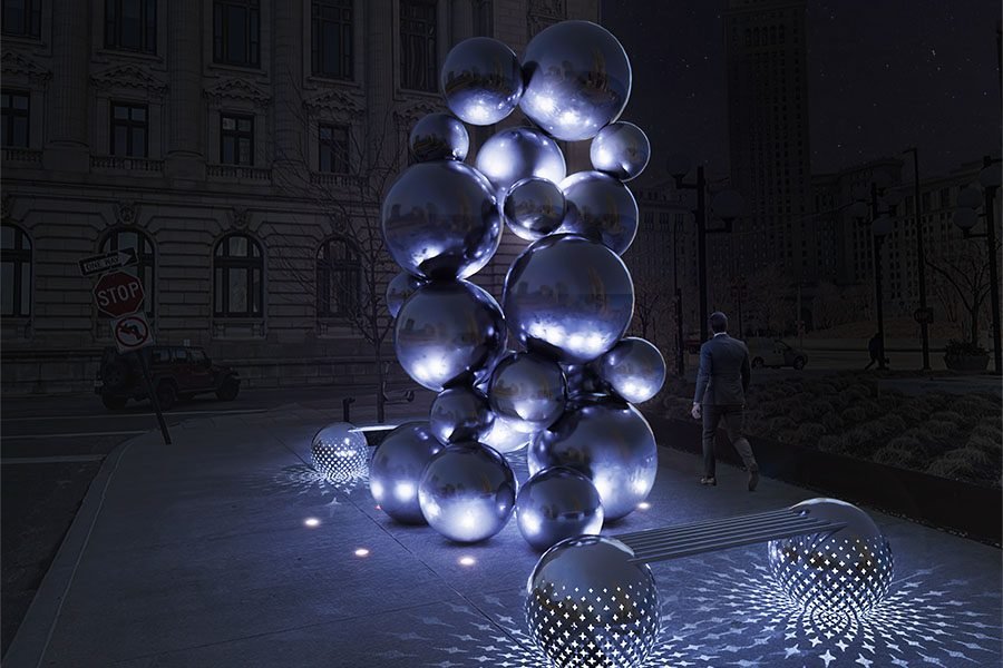 Illuminated stainless-steel sphere sculpture with matching LED bench in a city plaza at night
