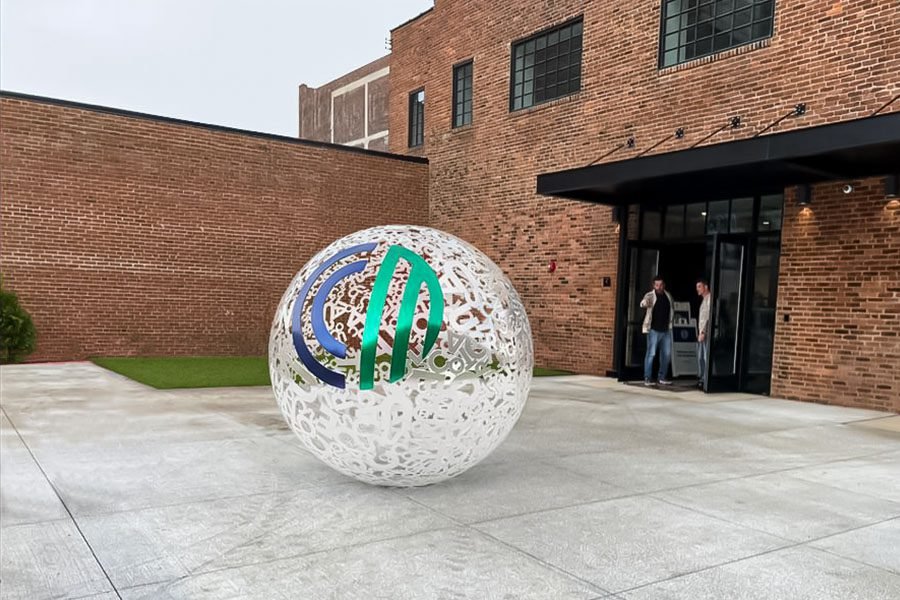 stainless steel sphere art with company logo