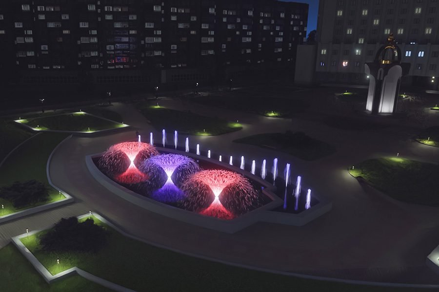 colorful illuminated fountain at night with glowing water jets in city plaza