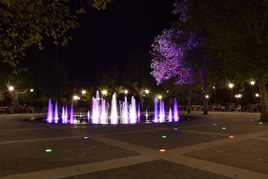 Circular park fountain with illuminated water choreography