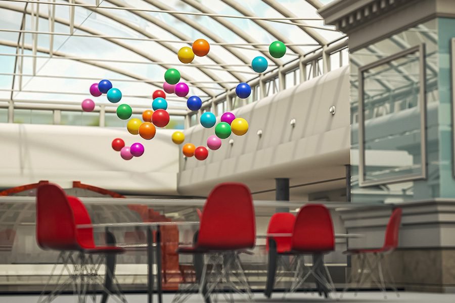 large kinetic installation with colorful suspended spheres in mall
